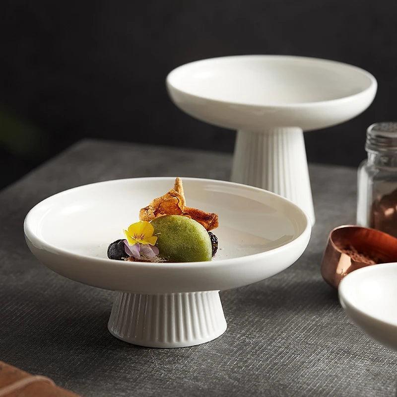 Elegant dessert pedestal plate holding plated mousse and berries