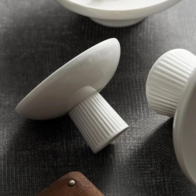 Close-up of white ceramic cake stand dish underside detail