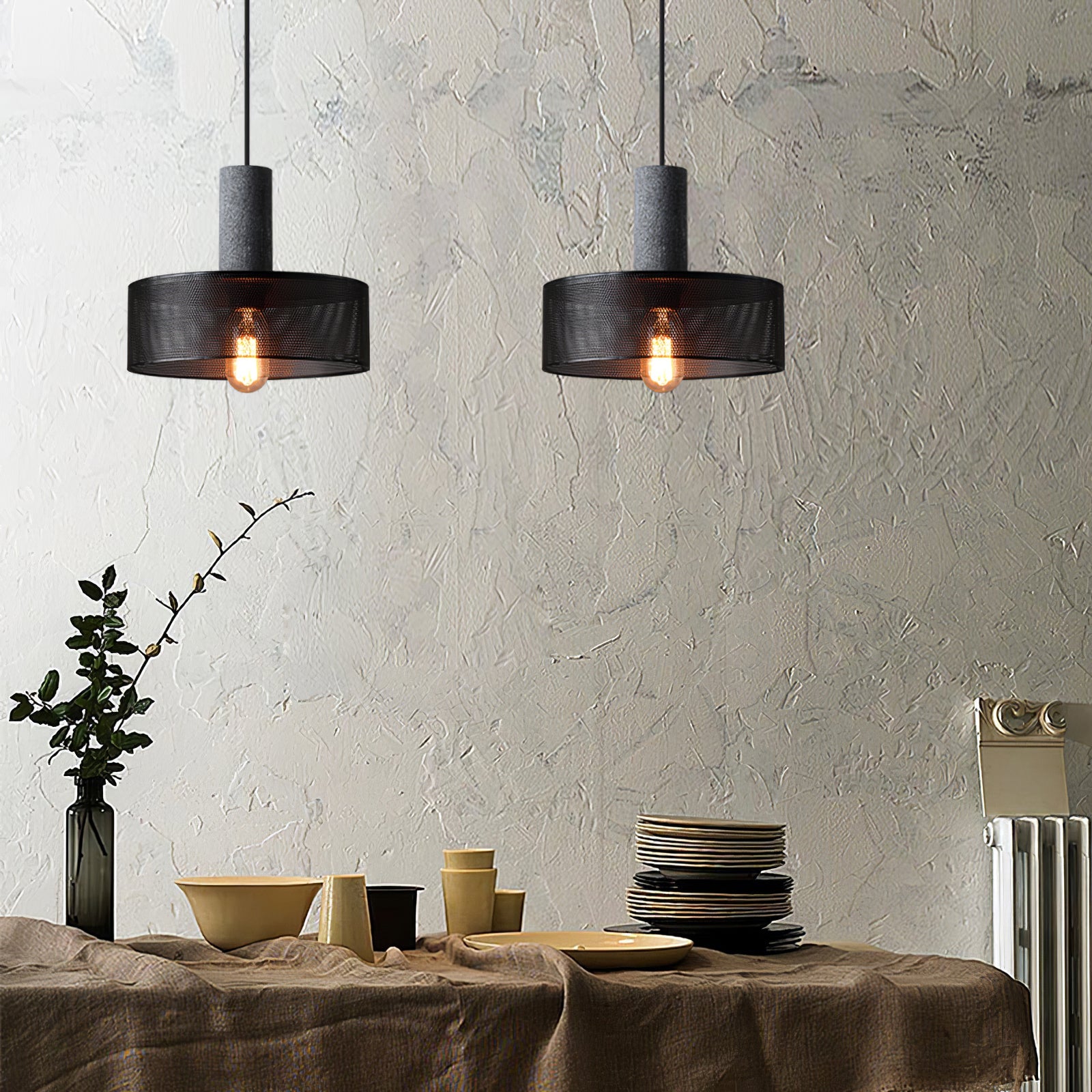 Multi-light dining chandelier set over table with concrete and mesh shades