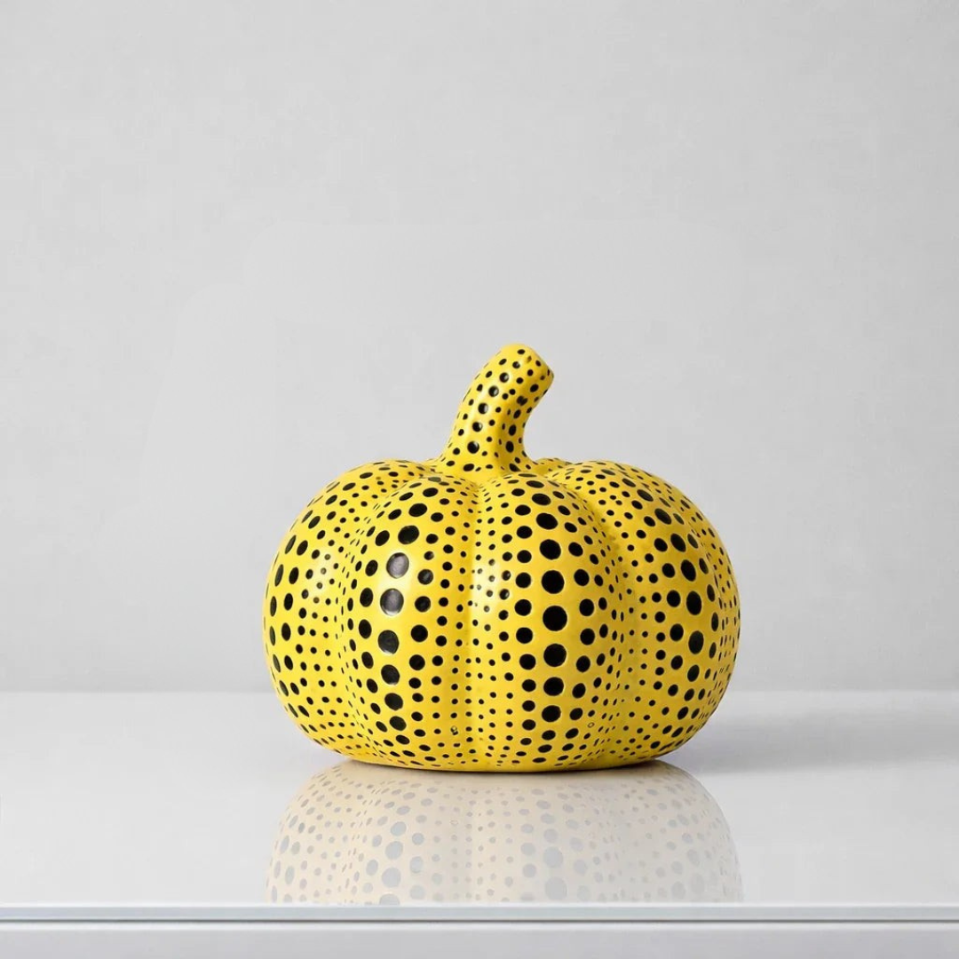 Glossy yellow polka dot pumpkin home decor with vertical lobes and reflection
