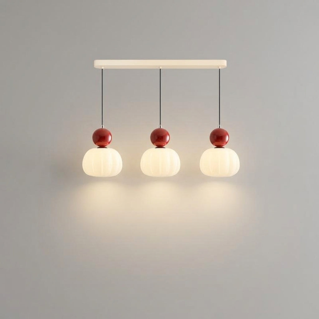 Linear pendant light with red sphere finials
