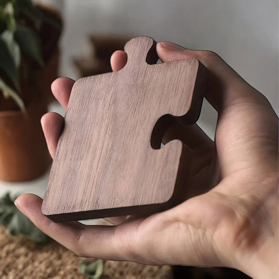 Natural walnut wood puzzle piece coaster showing interlocking edges and smooth grain
