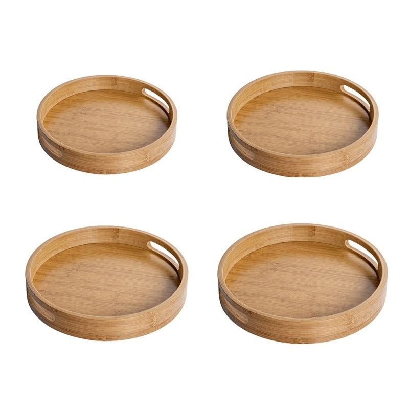Top-down view of four round bamboo serving trays arranged in grid pattern with visible grain