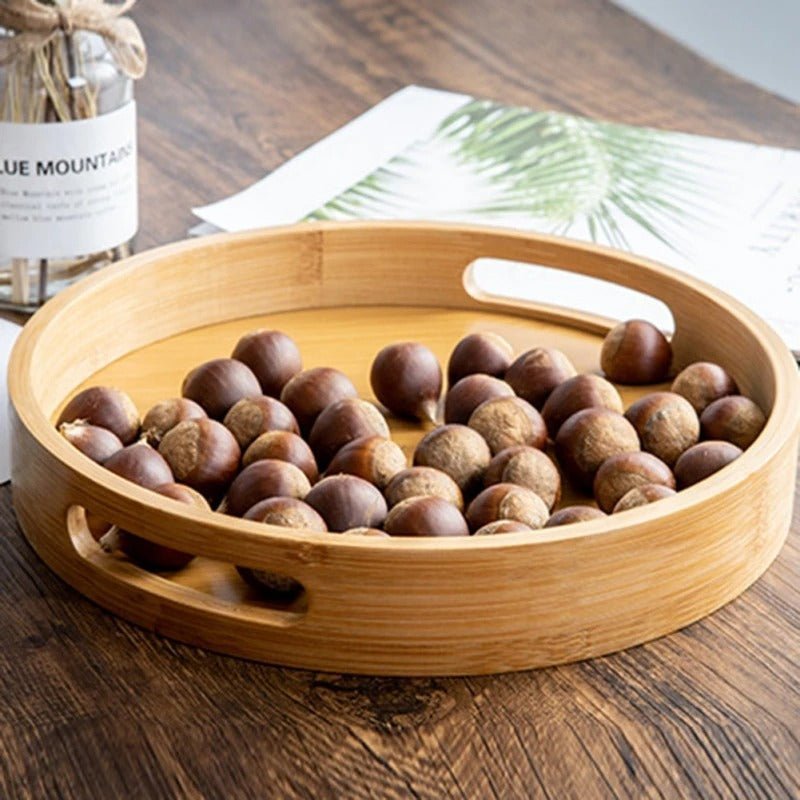 Bamboo serving tray filled with roasted chestnuts highlighting natural wood texture and handles