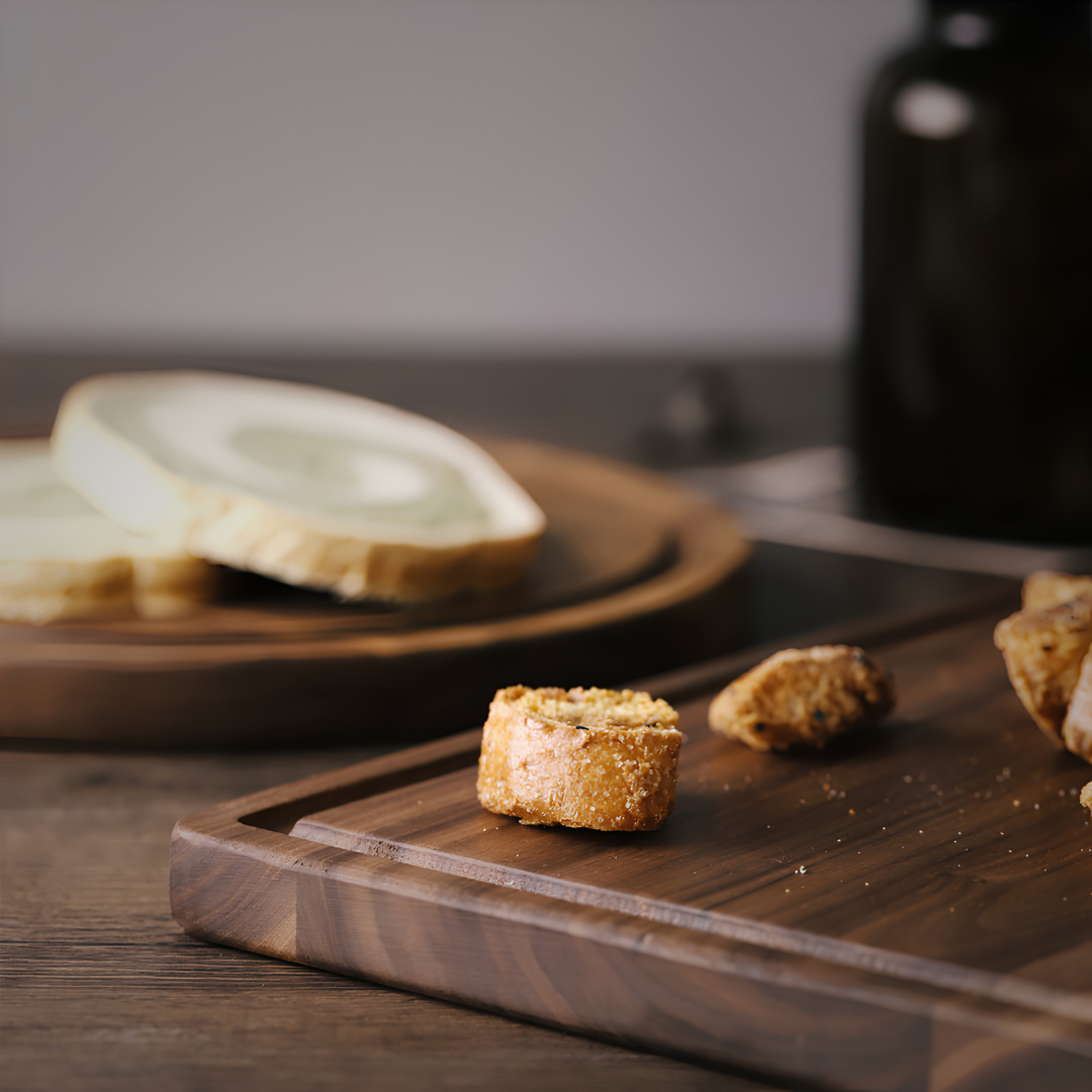 Rectangular walnut wood cutting board with beveled edges and grain detail