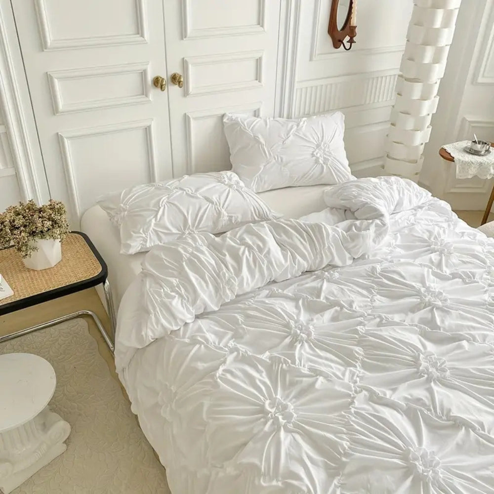 Elevated view of white pinch-pleated flower duvet cover set