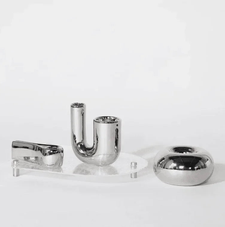 Complete silver chrome candle holder set components on acrylic base