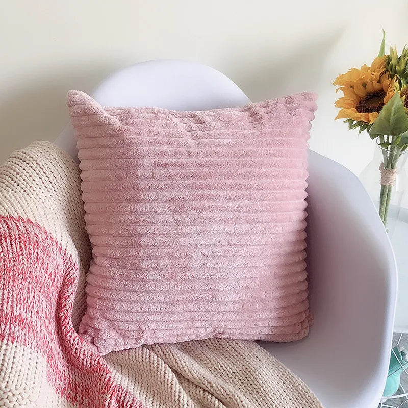 Soft pink ribbed corduroy flannel square pillowcase on modern chair
