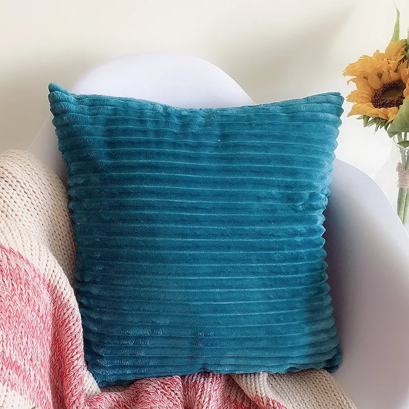 Teal ribbed corduroy flannel square pillowcase on white modern chair