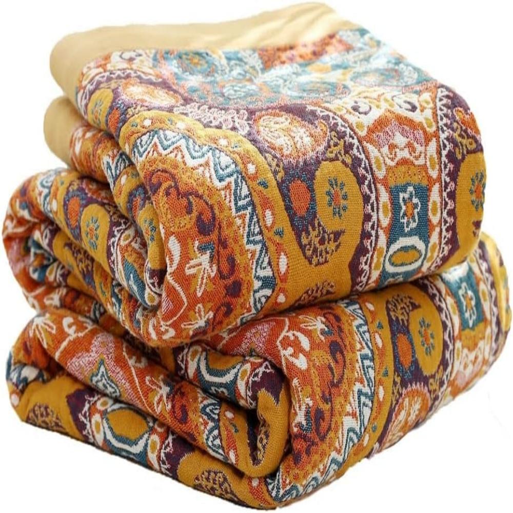 Folded vibrant kaleidoscopic reversible blanket stacked neatly showing woven cotton fabric