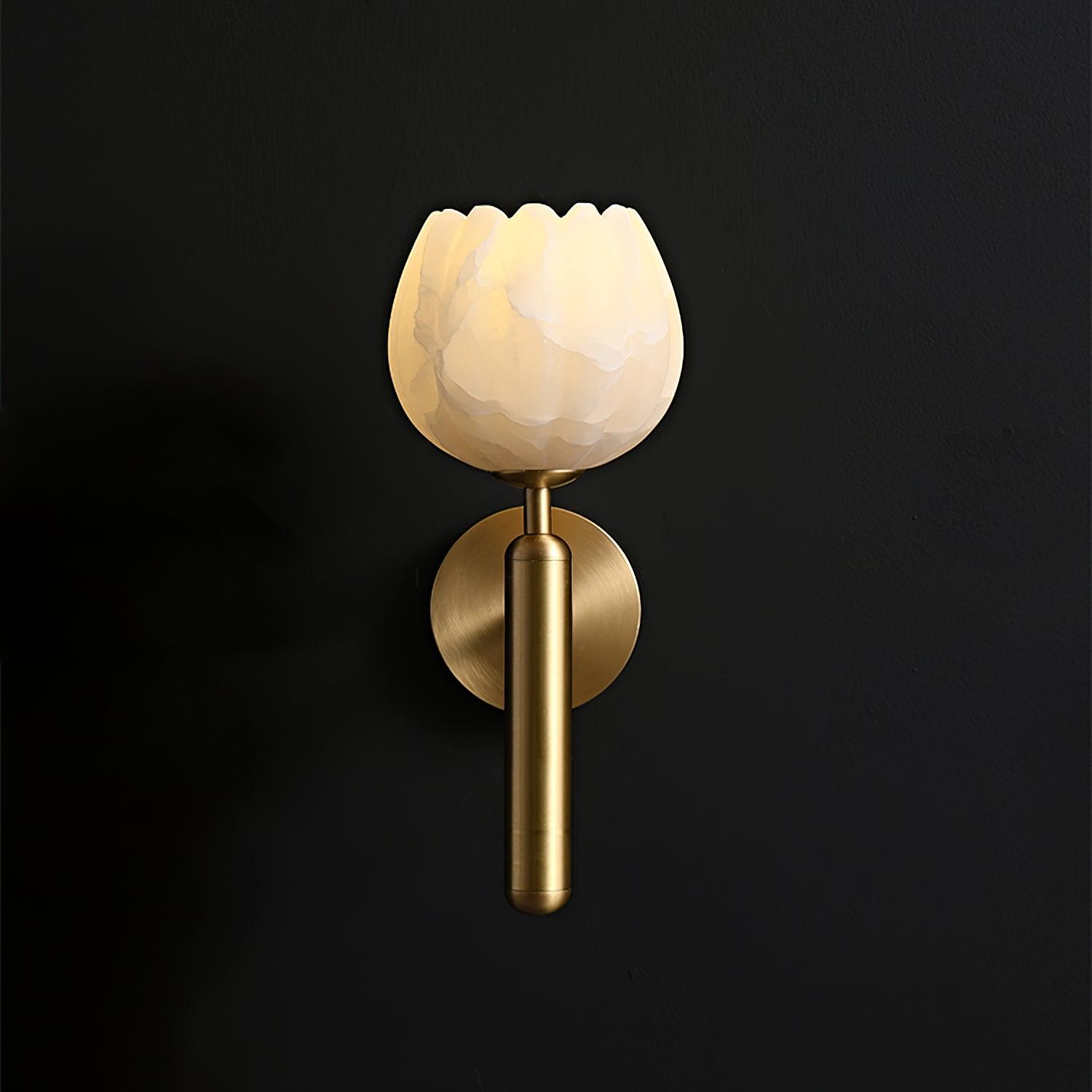 Close-up of carved alabaster flower shade and brushed brass hardware
