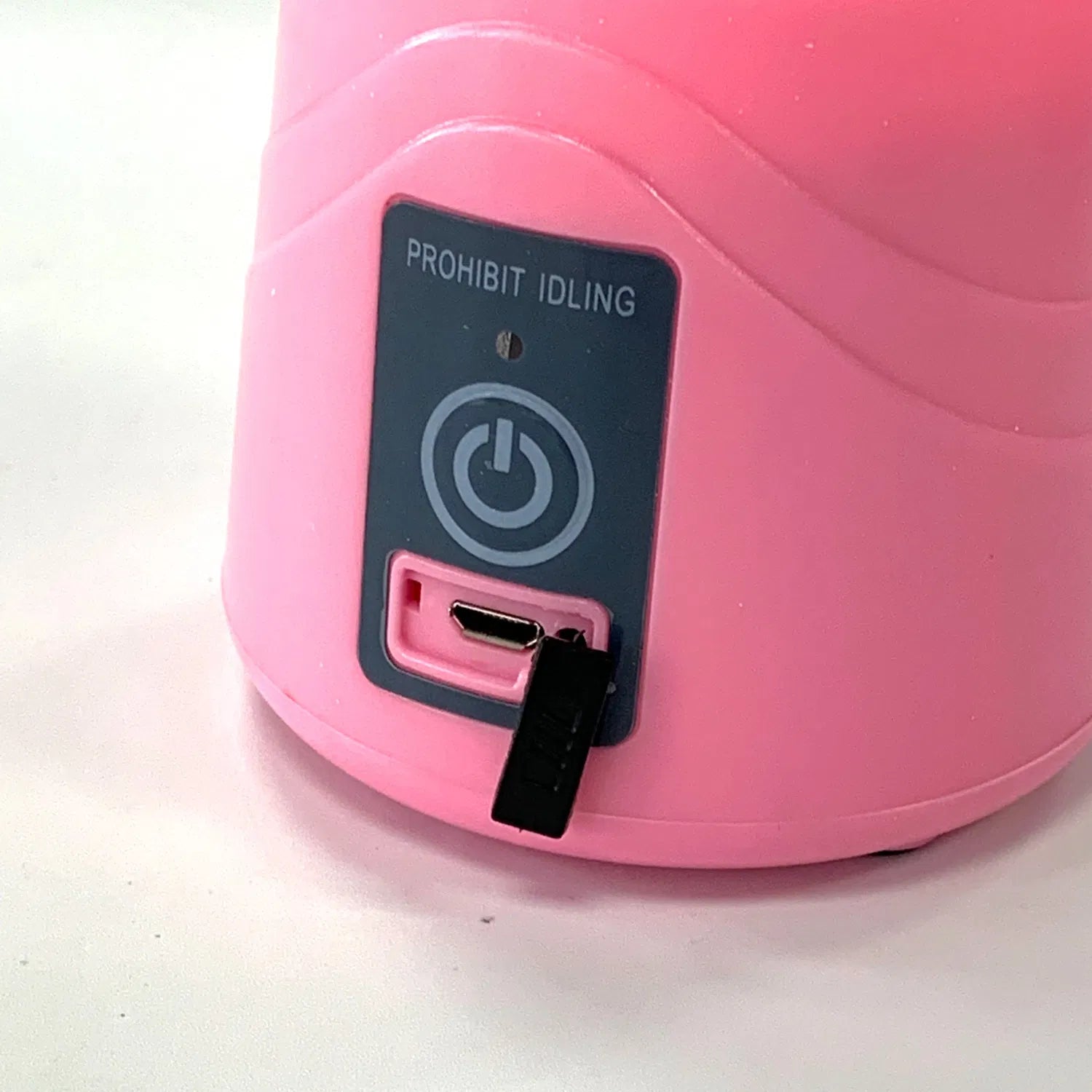 Pink portable blender base with USB-C port and Prohibit Idling warning label