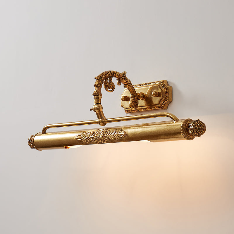 Front view of vintage brass picture light with decorative molding and warm glow