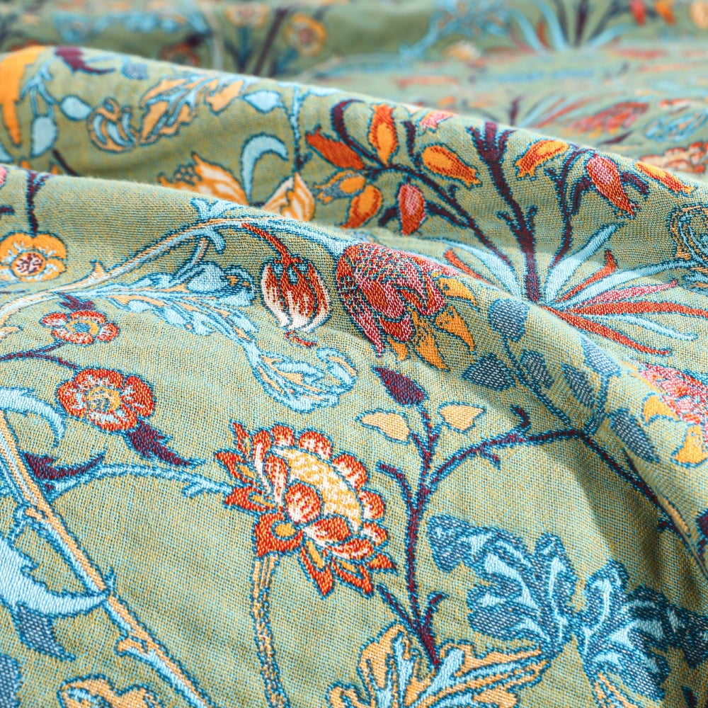 Vintage floral jacquard cotton blanket close-up green with orange and blue flowers