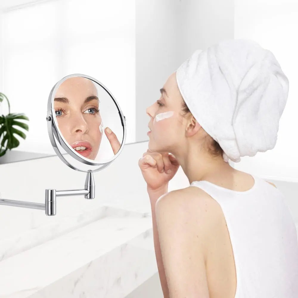 Woman applying skincare using adjustable chrome wall mounted bathroom vanity mirror
