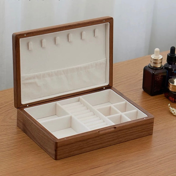 Dark walnut jewelry box interior with ring ridges and storage compartments