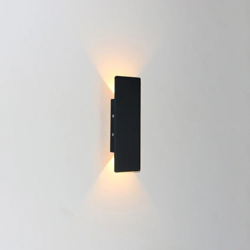 Angled view of matte black modern outdoor wall sconce design