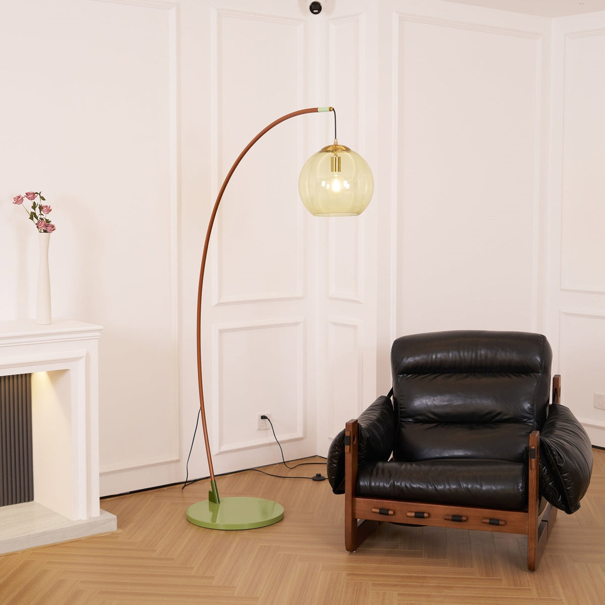 Maintained House Amber Globe Arc Floor Lamp - Beside a leather armchair