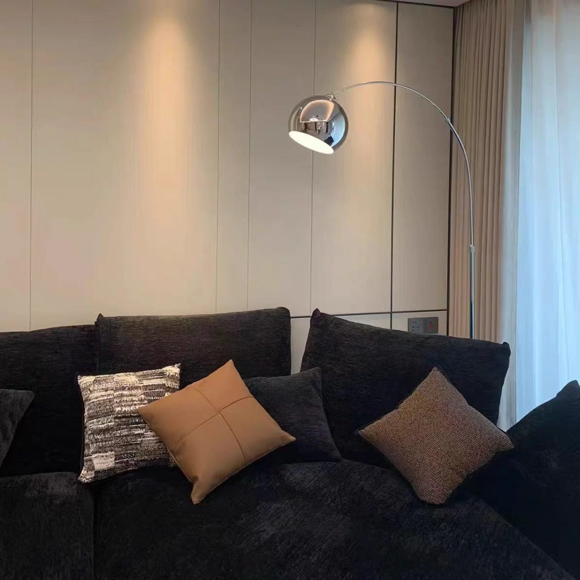 Maintained House Globe Arc Floor Lamp - Over a dark sofa