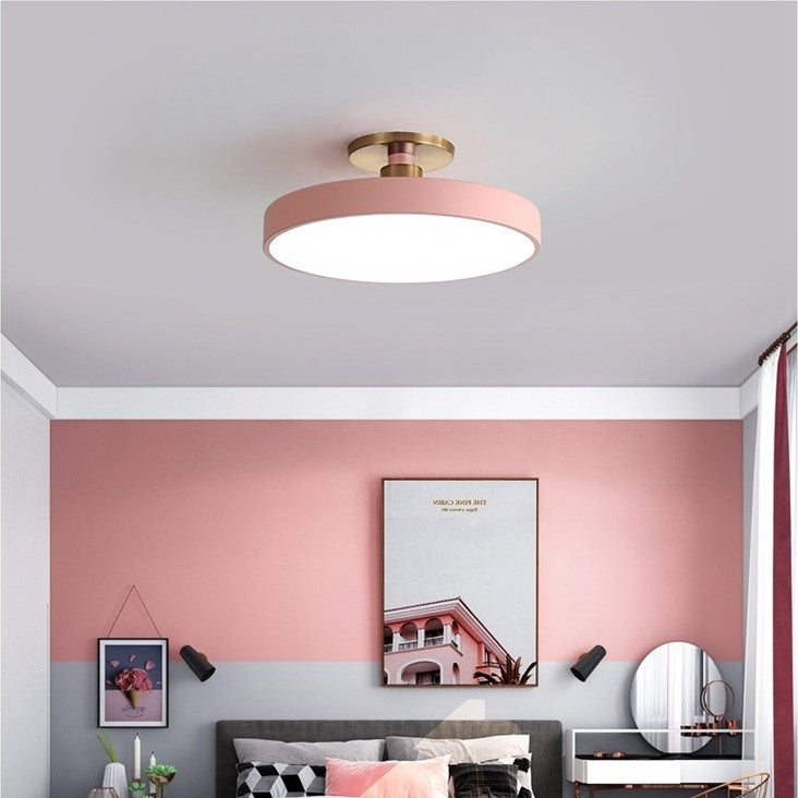 Maintained House Macaron Drum LED Ceiling Light - Pink in a pink-walled guest room
