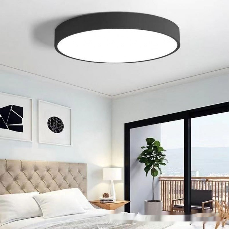 Maintained House Macaron Flush Mount LED Ceiling Light - Black in a bedroom with a balcony view