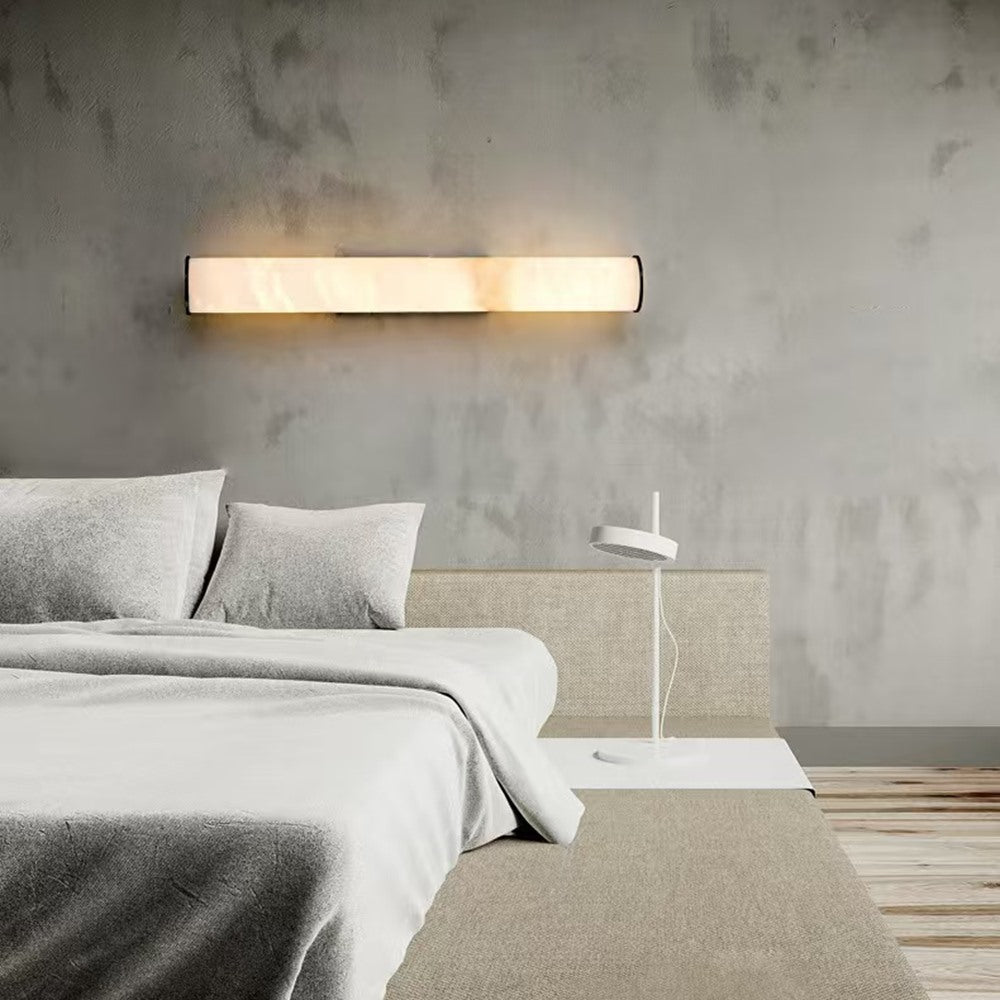 Maintained House Marble Tube Wall Sconce - Mounted horizontally above a bed