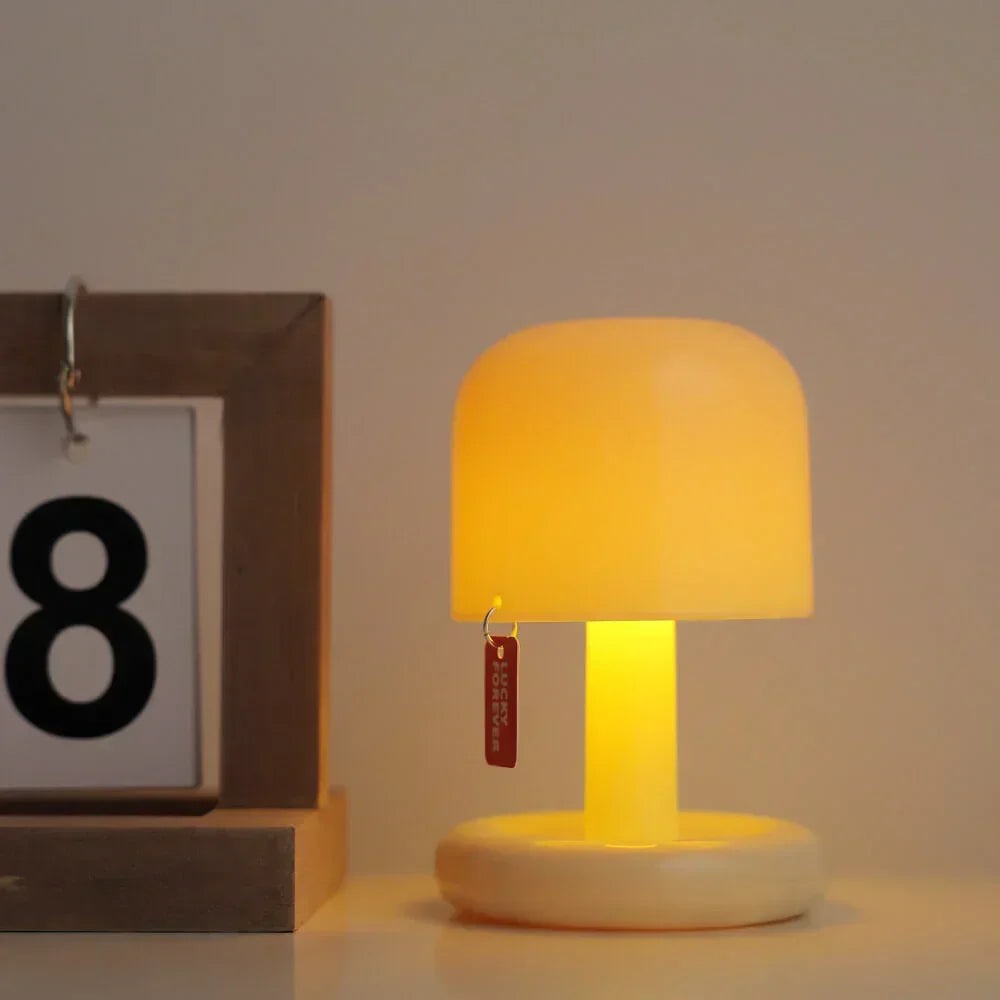 Maintained House Mini Sunset Mushroom Lamp - Glowing by a desk calendar