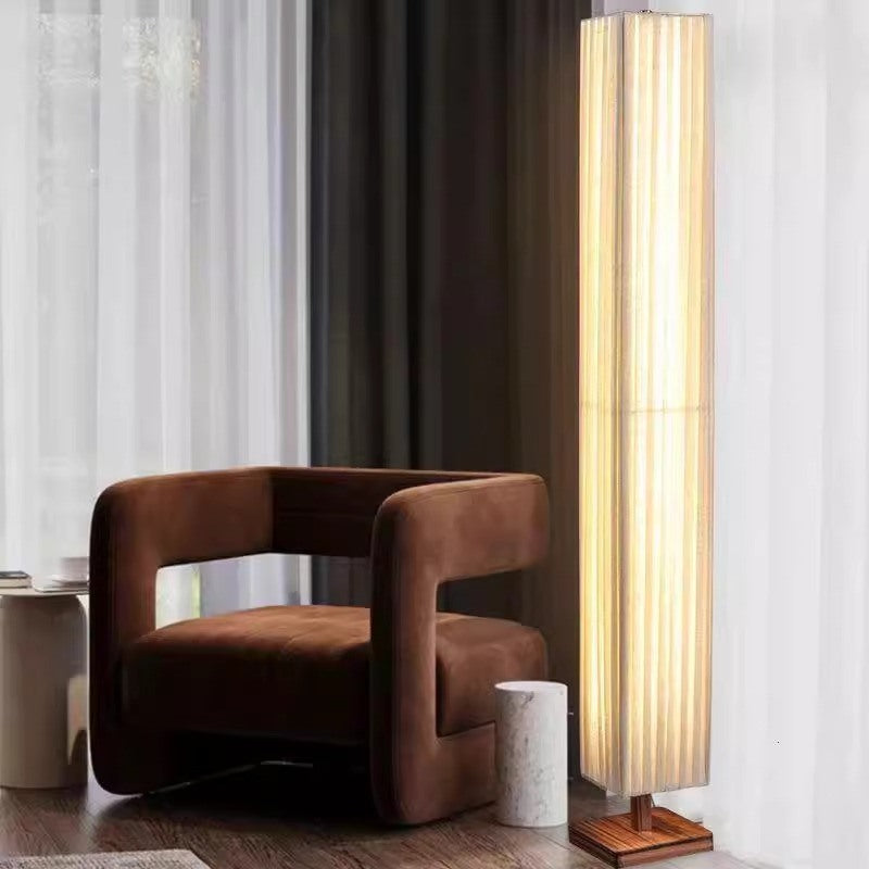 Maintained House Pleated Linen Column Floor Lamp - Beside a velvet armchair