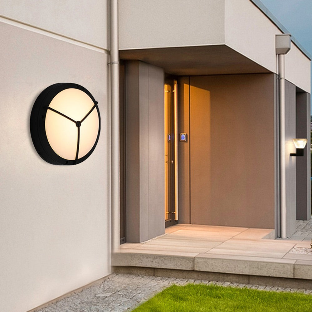 Maintained House Round Outdoor LED Wall Light - Three Spoke style beside a front entrance