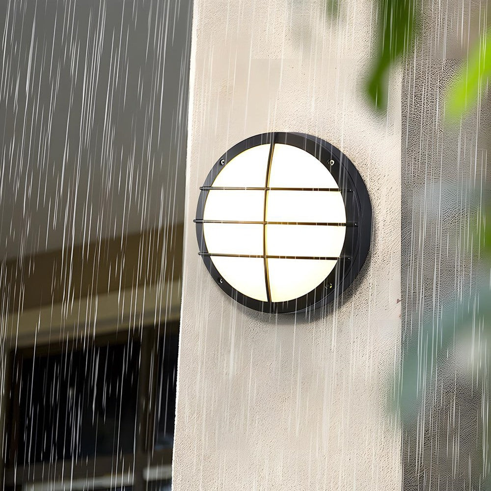 Maintained House Round Outdoor LED Wall Light - Grid style lit in the rain