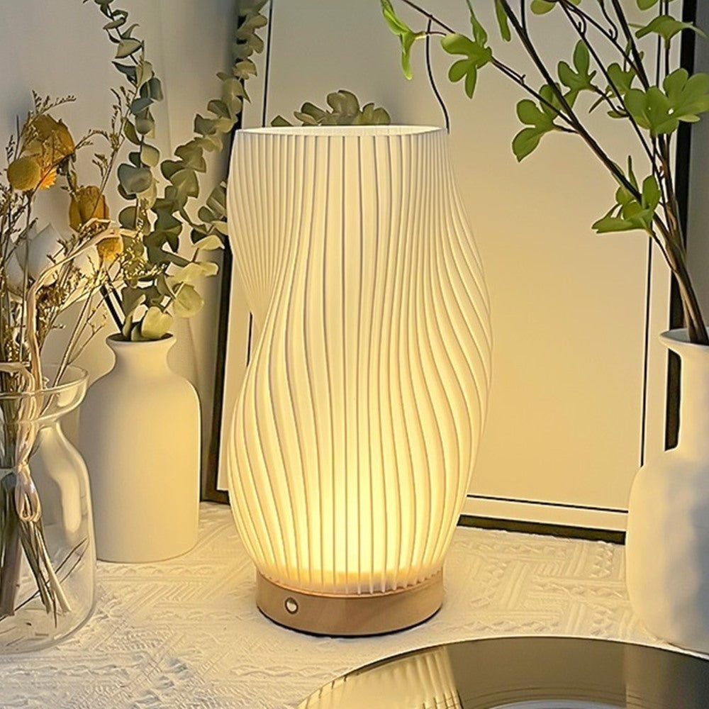Maintained House Sculpted Wave Table Lamp - Curve lamp glowing on a side table