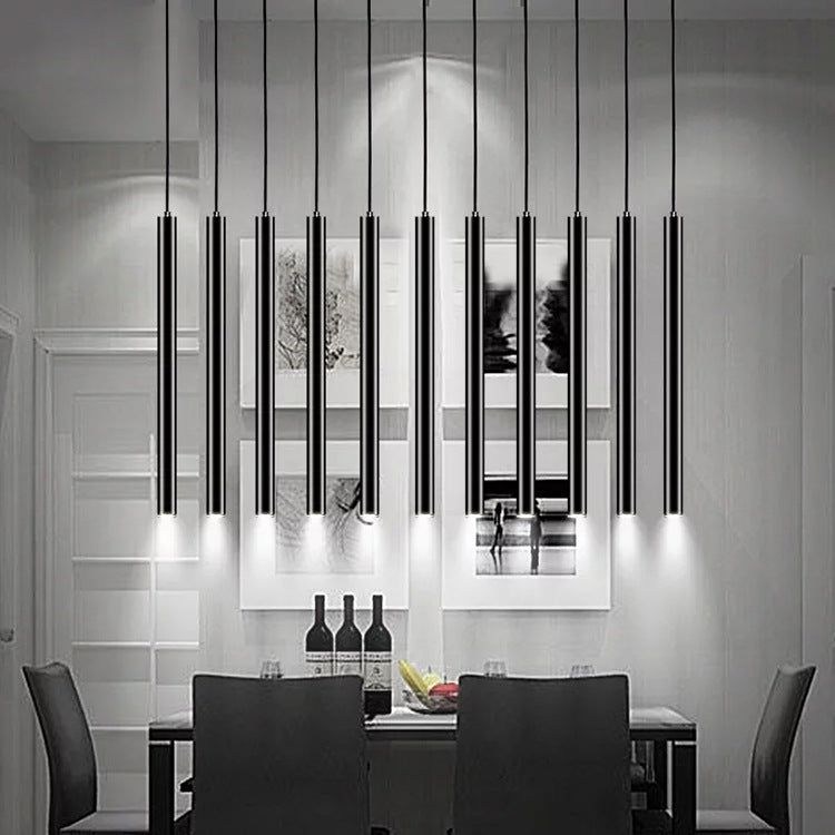 Maintained House Slim Tube LED Pendant Light - A row of black tubes over a dining table
