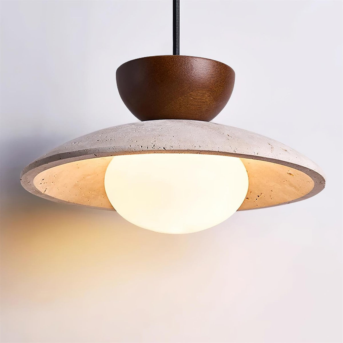 Maintained House Travertine Saucer Pendant Light - Walnut, glowing close-up