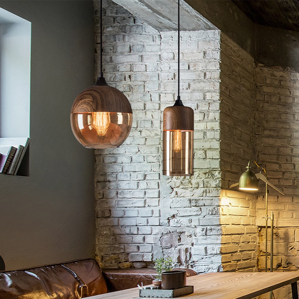 Maintained House Wood Grain Amber Glass Pendant Light - Set of 2: globe and cylinder by a brick wall